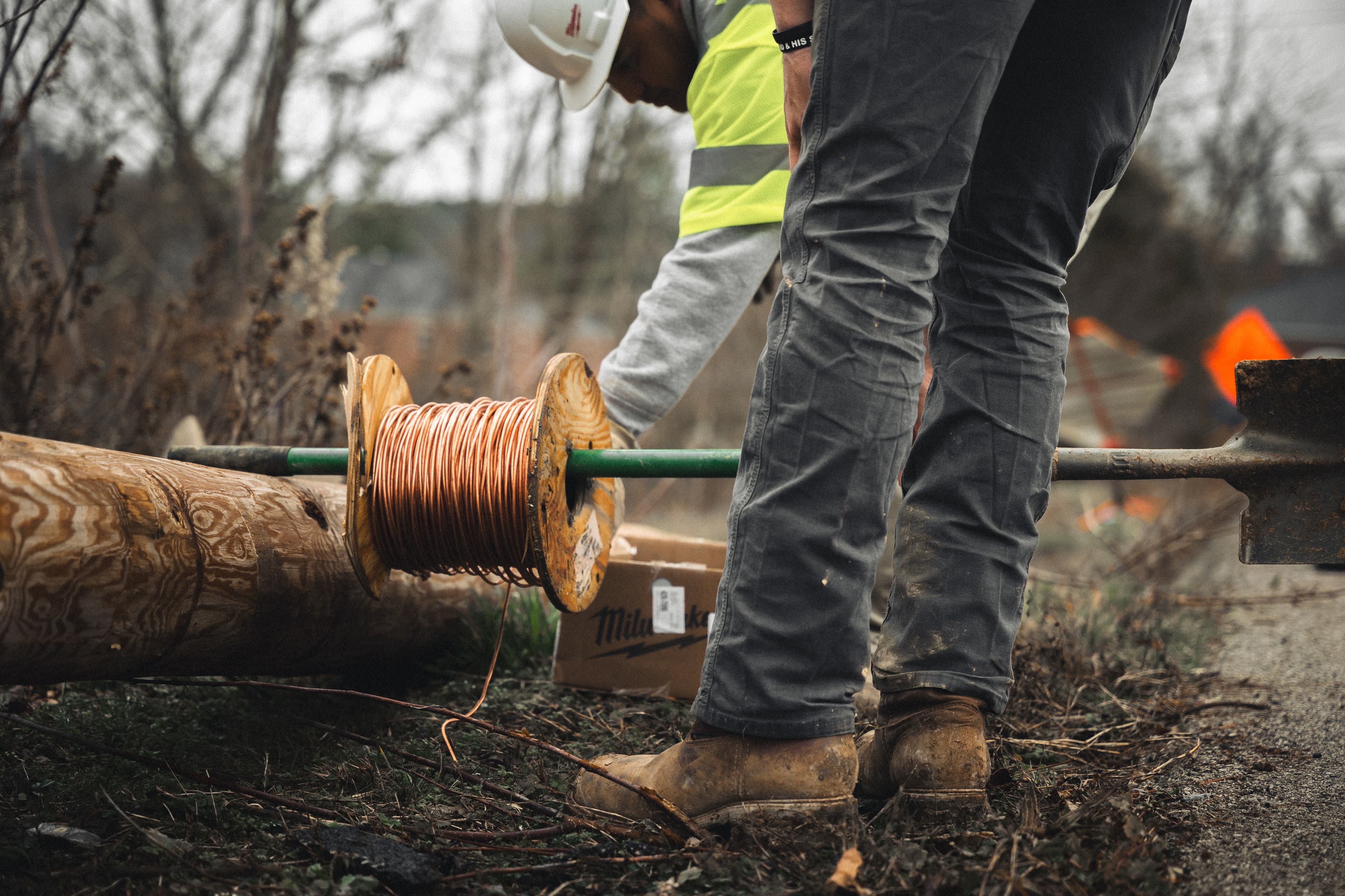 Lineman handling conductor wire on distribution project